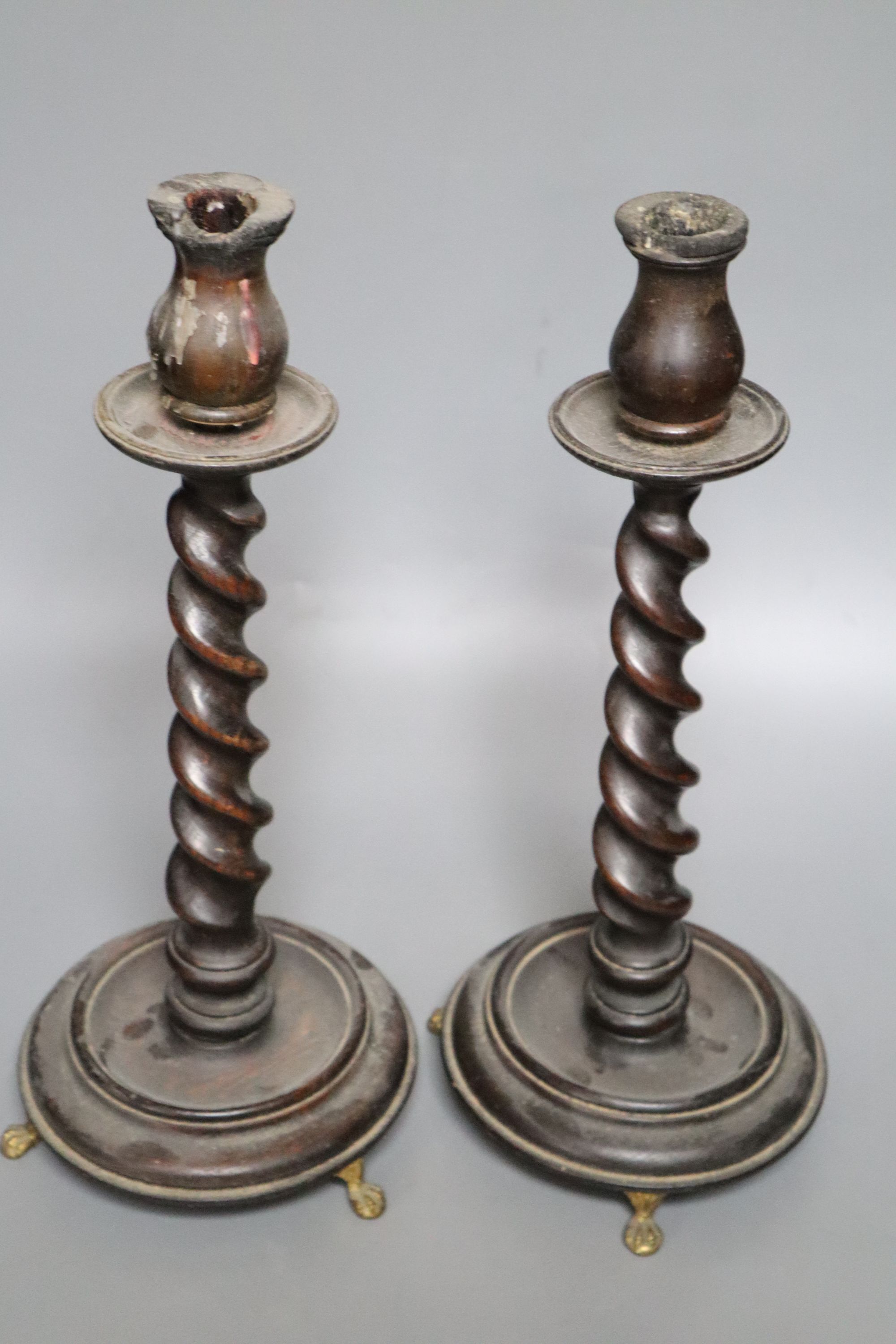 A pair of carved wood twist stem candlesticks, on gilt metal feet, height 39cm